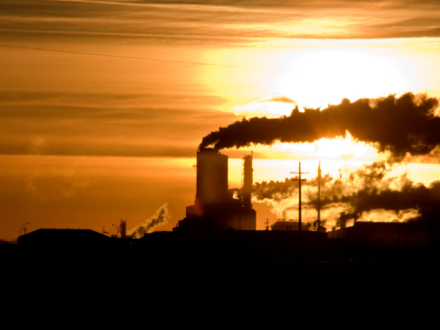 Smoke stacks in Saskatchewan, Canada, symbolize the ongoing challenges of climate change and environmental impact, highlighting the region's need for sustainable energy policies.